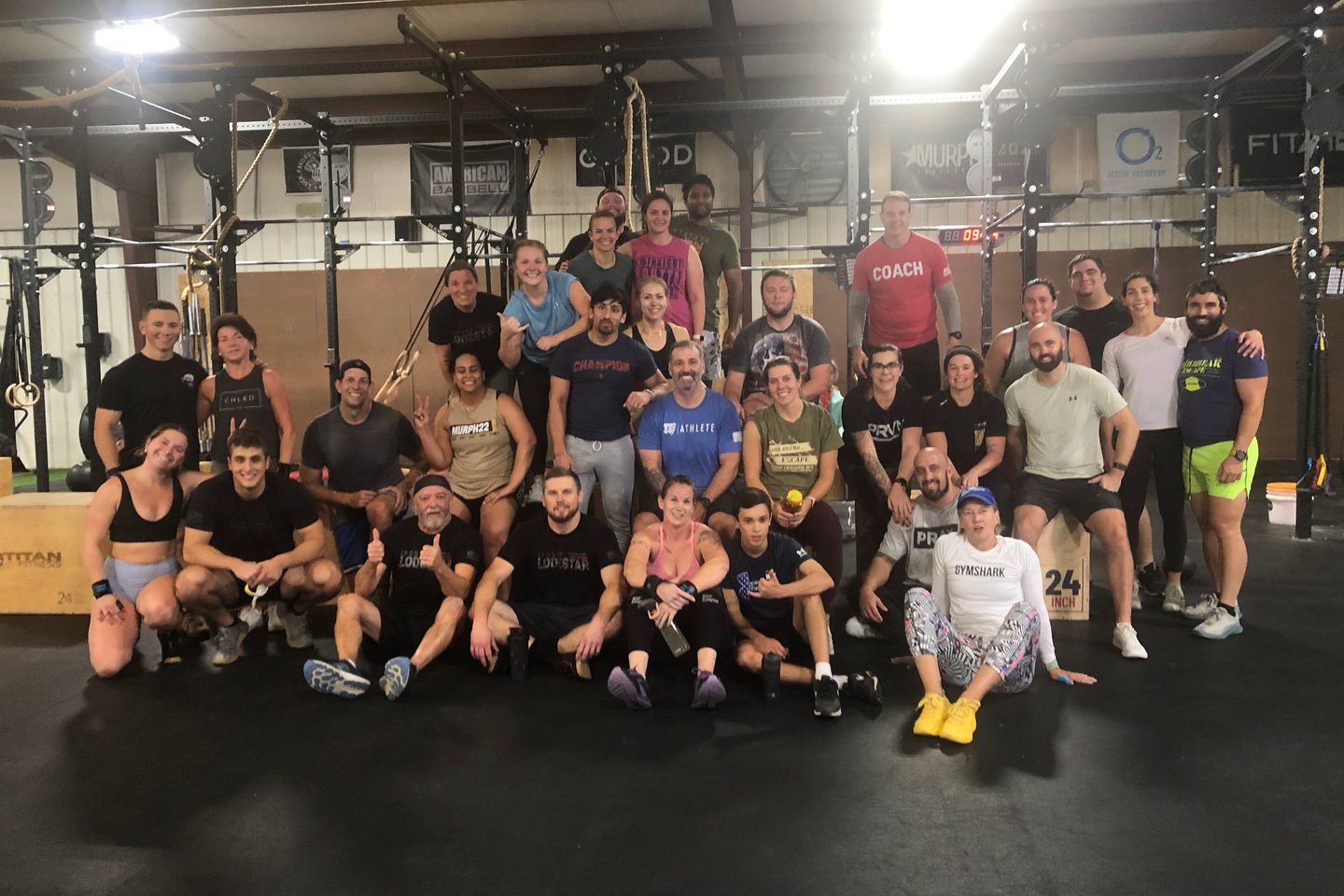 A full Lodestar class gathered together on the gym floor after a workout