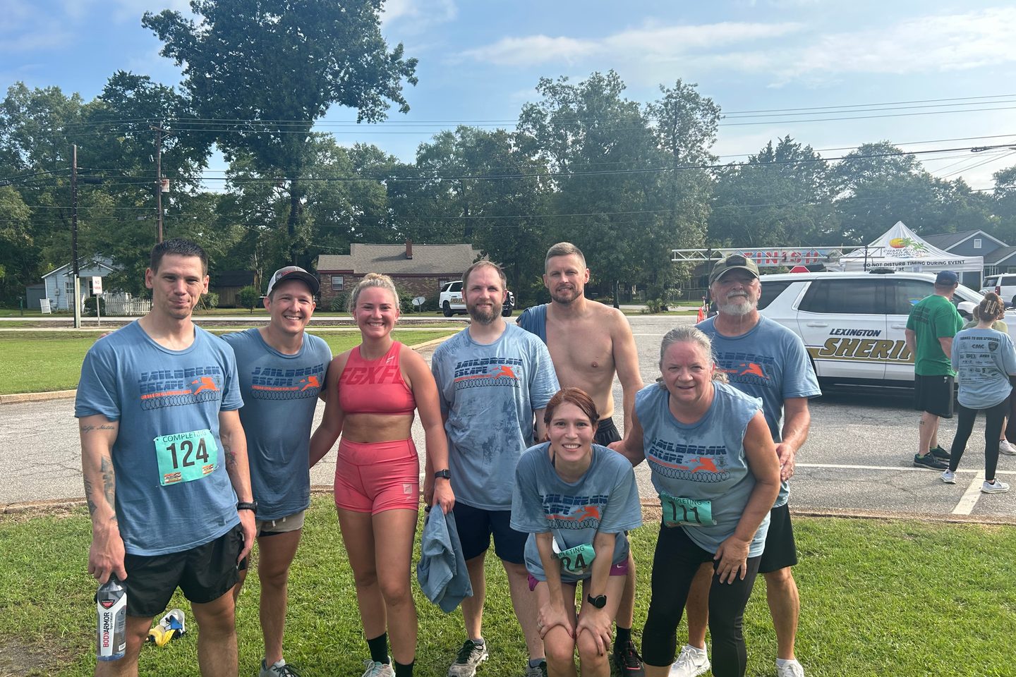 Lodestar members together after a road race, several still wearing their numbered bibs